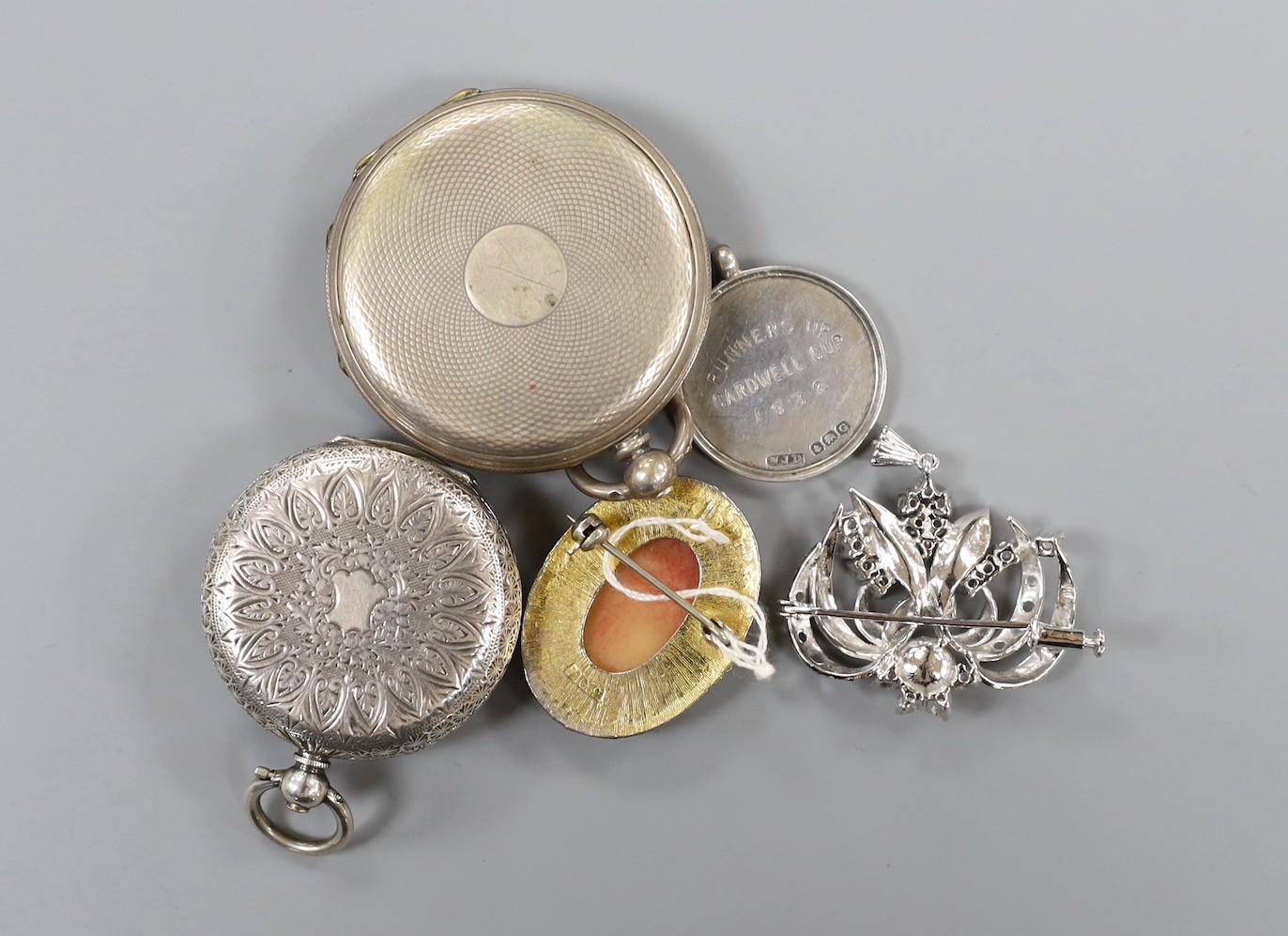 A mixed group of assorted silver and costume jewellery including a silver albert, Scottish hardstone brooch and two silver medallions, a silver fob watch, a white metal open faced pocket watch and a lady's steel Talis wr